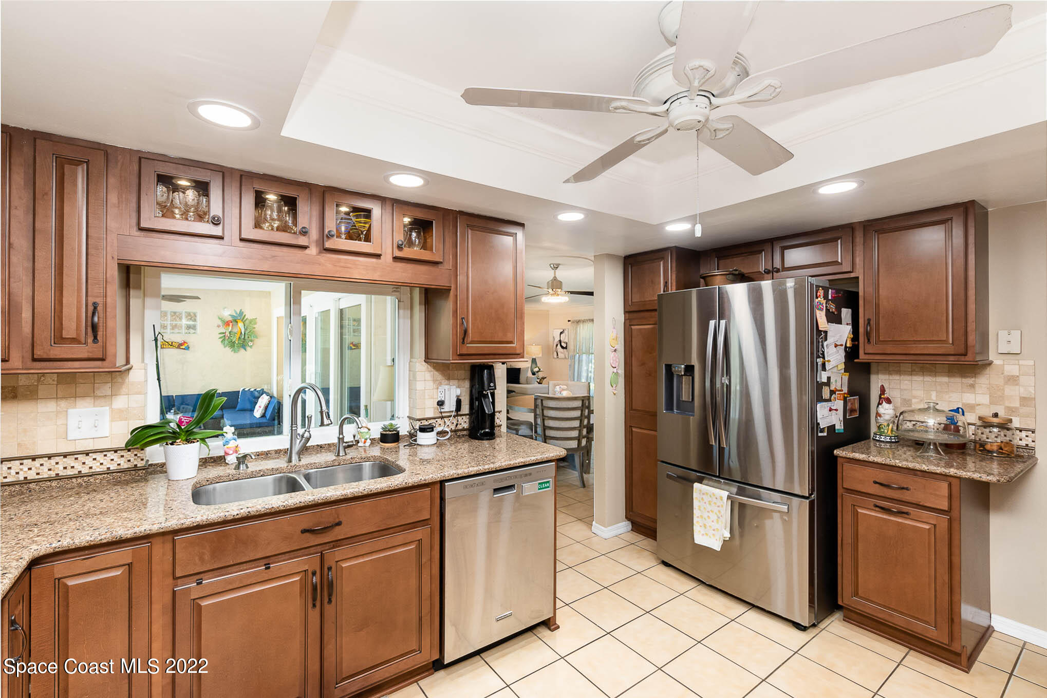 1496 Meadowbrook Road Northeast Palm Bay, FL 32905 - Photo 19 of 25 a kitchen with stainless steel appliances granite countertop a refrigerator and a sink