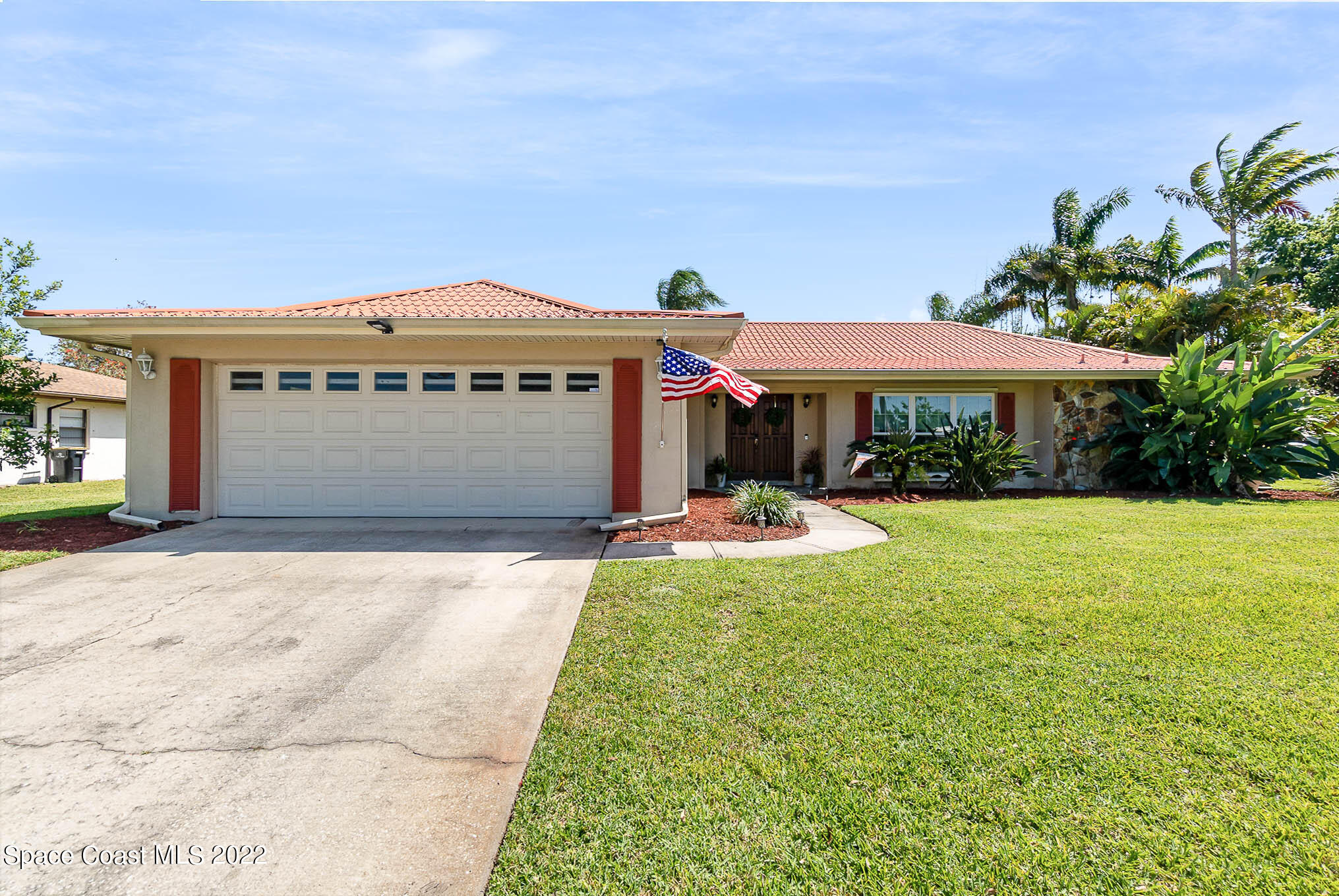 1496 Meadowbrook Road Northeast Palm Bay, FL 32905 - Photo 2 of 25 a front view of a house with yard