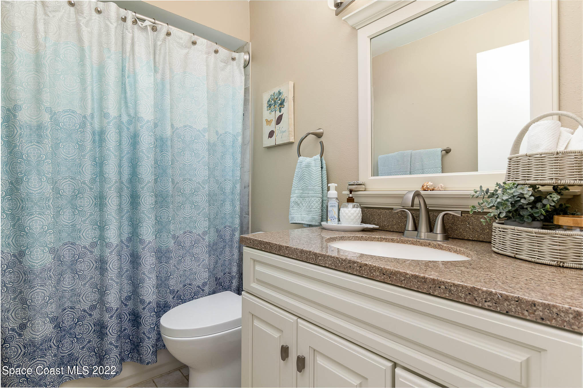 1496 Meadowbrook Road Northeast Palm Bay, FL 32905 - Photo 22 of 25 a bathroom with a granite countertop sink a toilet and shower