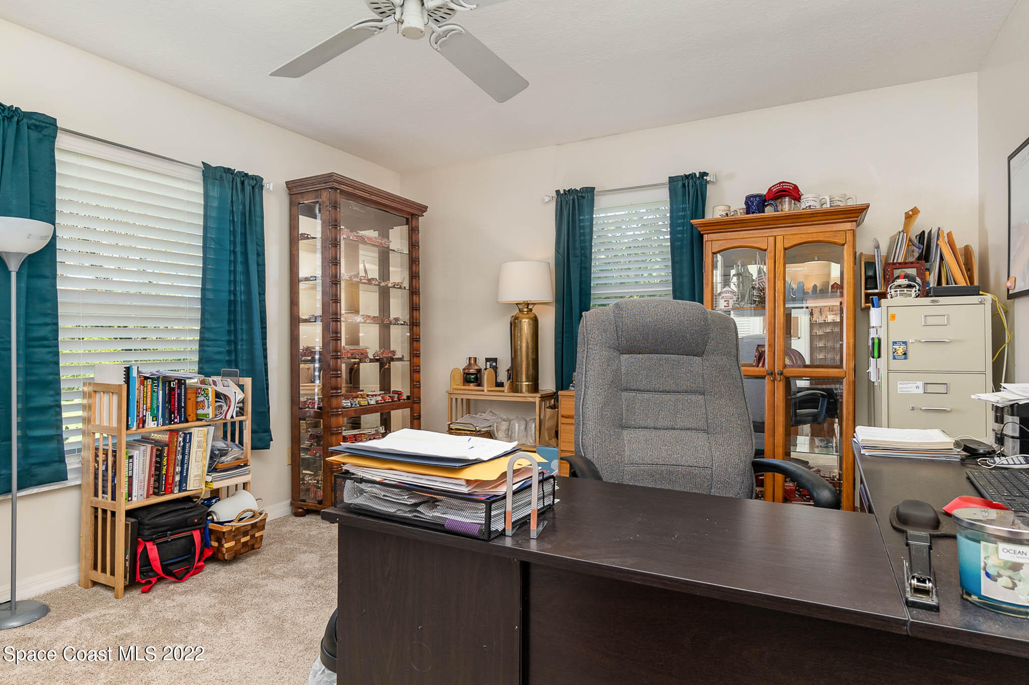 1496 Meadowbrook Road Northeast Palm Bay, FL 32905 - Photo 23 of 25 a living room with furniture and a flat screen tv
