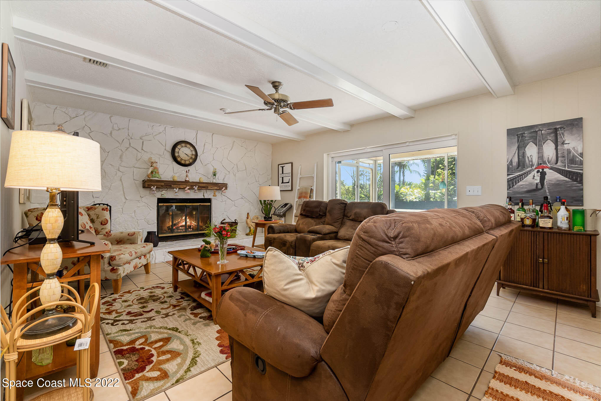 1496 Meadowbrook Road Northeast Palm Bay, FL 32905 - Photo 24 of 25 a living room with furniture a fireplace and a window