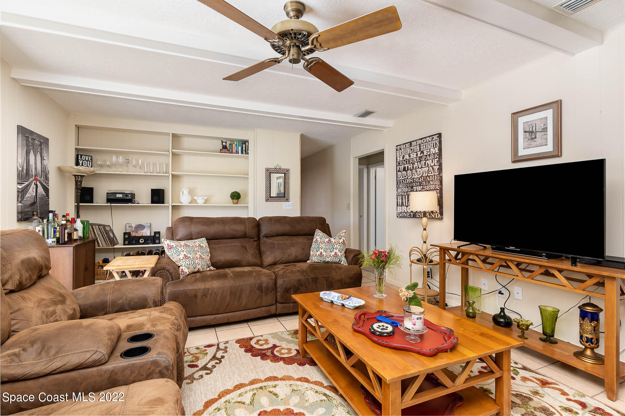 1496 Meadowbrook Road Northeast Palm Bay, FL 32905 - Photo 25 of 25 a living room with furniture and a flat screen tv