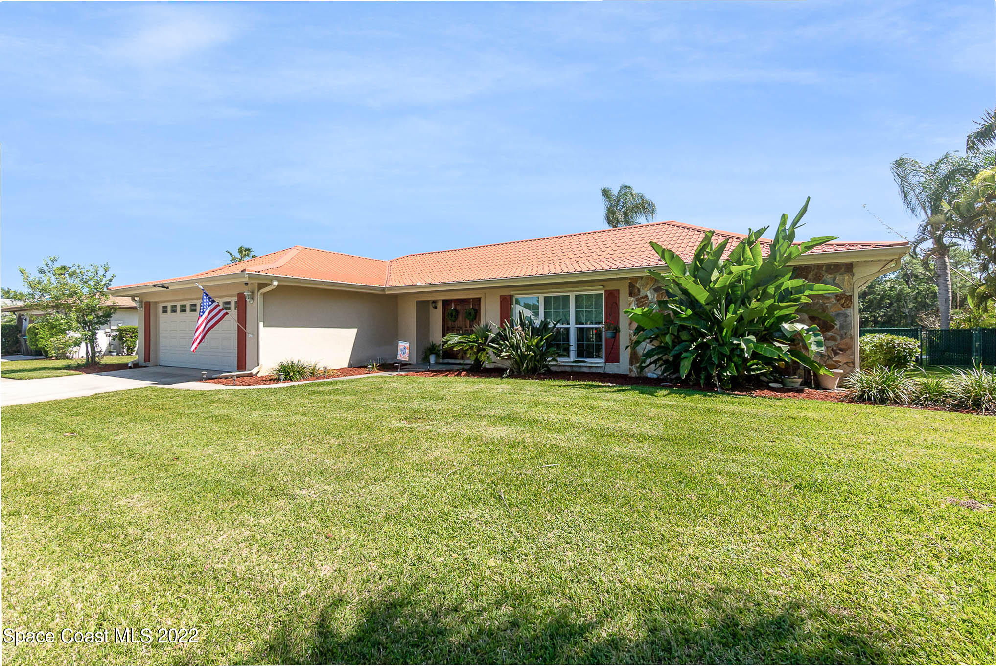1496 Meadowbrook Road Northeast Palm Bay, FL 32905 - Photo 3 of 25 a front view of a house with a garden