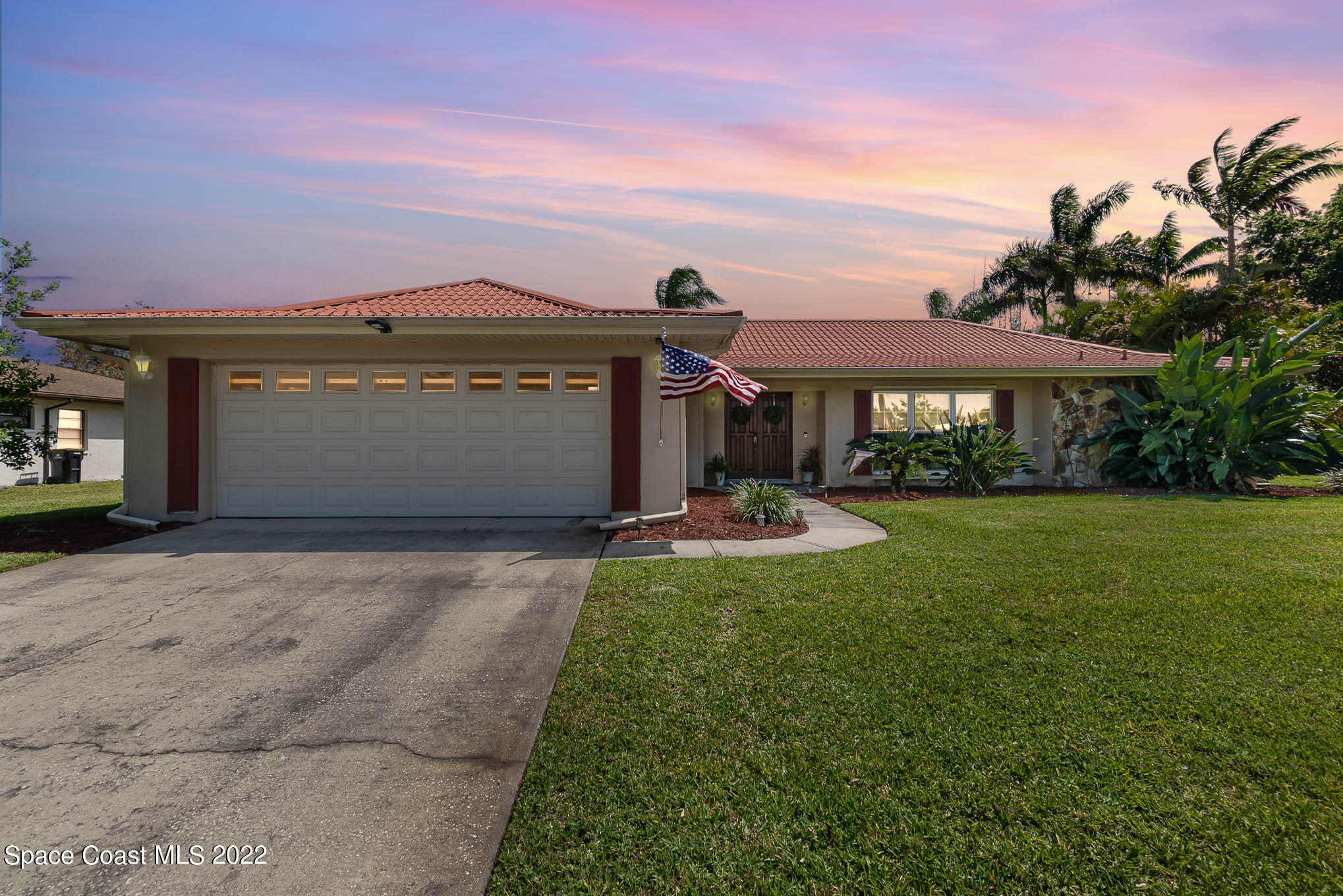1496 Meadowbrook Road Northeast Palm Bay, FL 32905 - Photo 4 of 25 a front view of a house with a yard