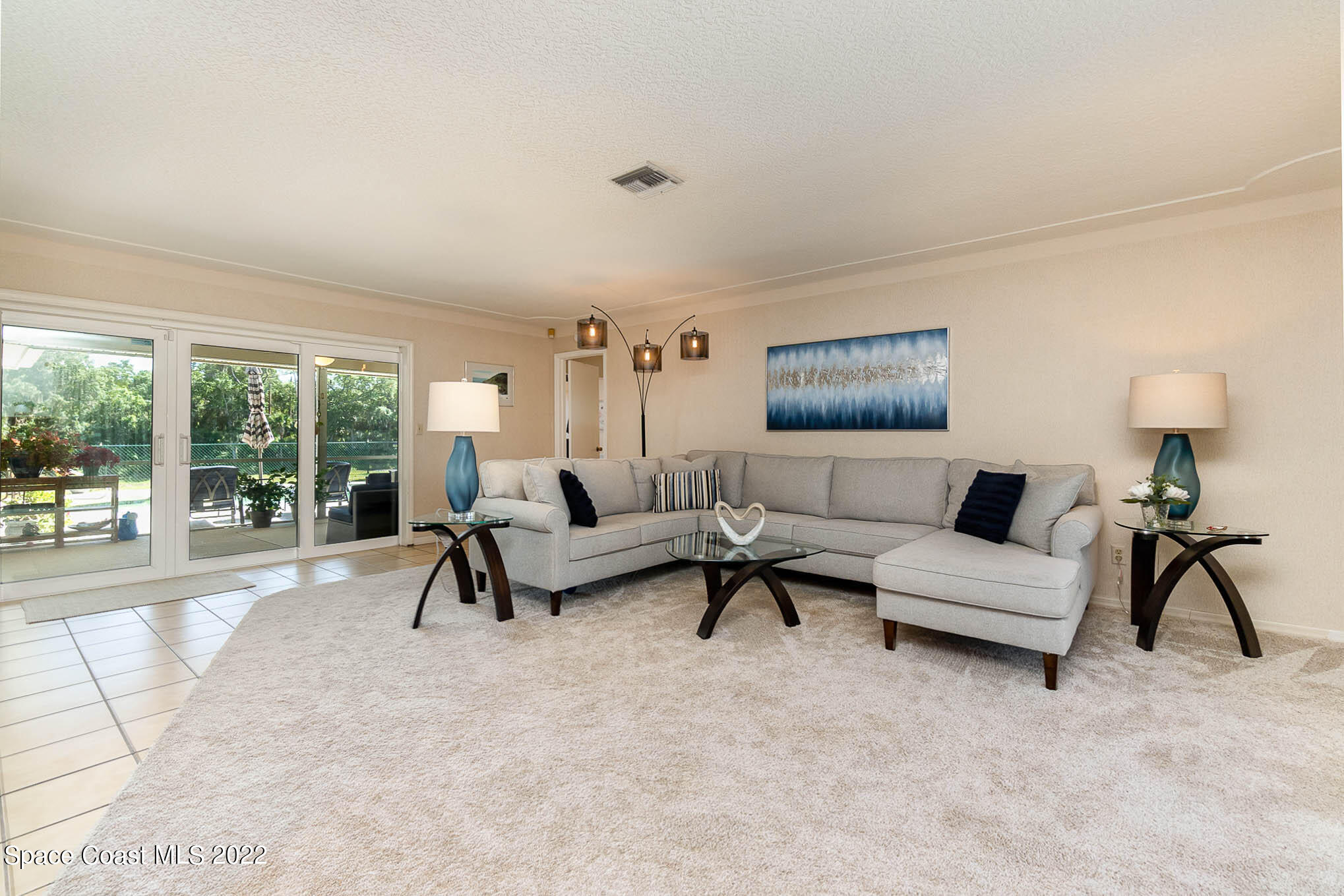 1496 Meadowbrook Road Northeast Palm Bay, FL 32905 - Photo 10 of 25 a living room with furniture and a large window