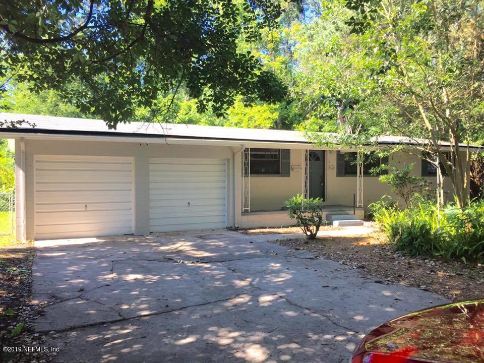 5107 Spring Glen Road Jacksonville, FL 32207 - Photo 1 of 16 a backyard of a house with yard and outdoor seating
