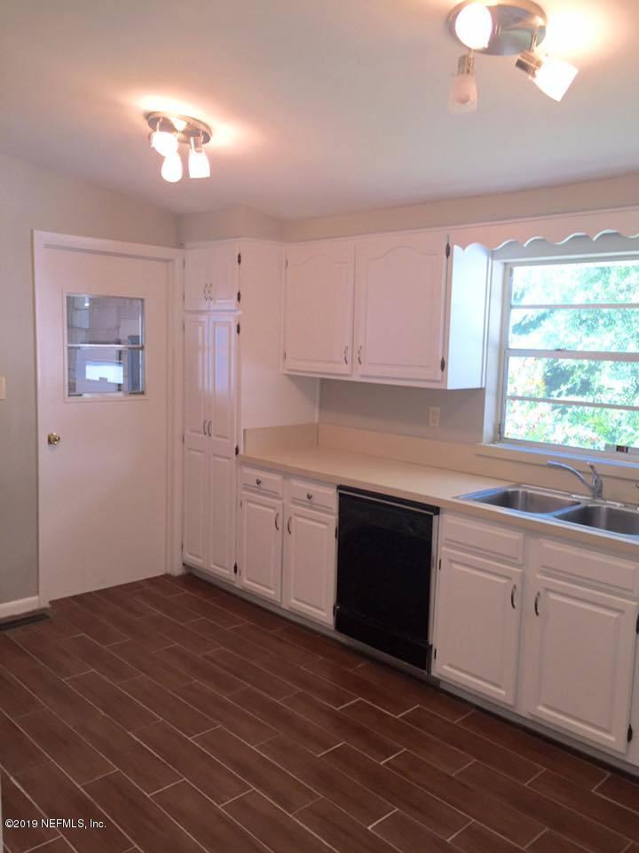 5107 Spring Glen Road Jacksonville, FL 32207 - Photo 12 of 16 a kitchen with a sink cabinets and window
