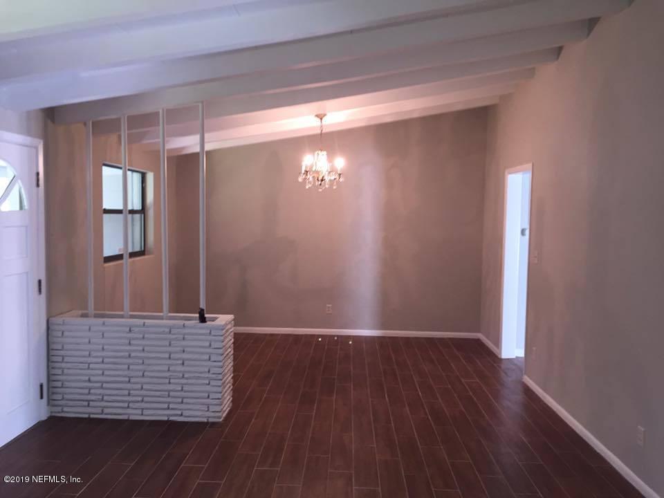5107 Spring Glen Road Jacksonville, FL 32207 - Photo 14 of 16 a view of room with window and wooden floor