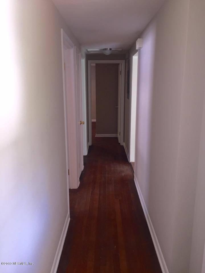 5107 Spring Glen Road Jacksonville, FL 32207 - Photo 3 of 16 a view of a hallway with wooden floor
