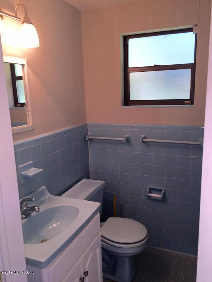 5107 Spring Glen Road Jacksonville, FL 32207 - Photo 5 of 16 a bathroom with a sink toilet and mirror