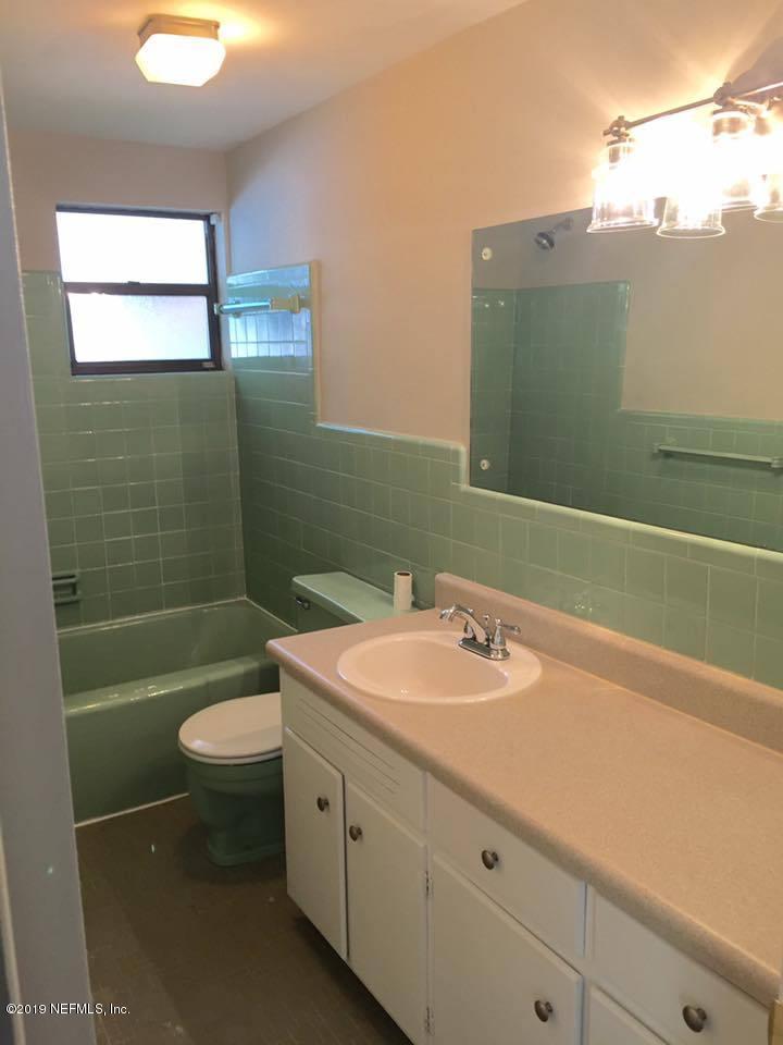 5107 Spring Glen Road Jacksonville, FL 32207 - Photo 8 of 16 a bathroom with a sink toilet and shower