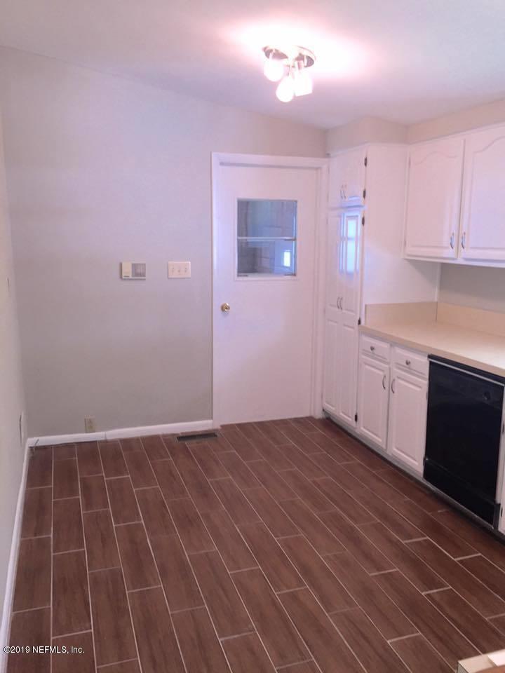 5107 Spring Glen Road Jacksonville, FL 32207 - Photo 9 of 16 a view of kitchen with granite countertop cabinets and sink