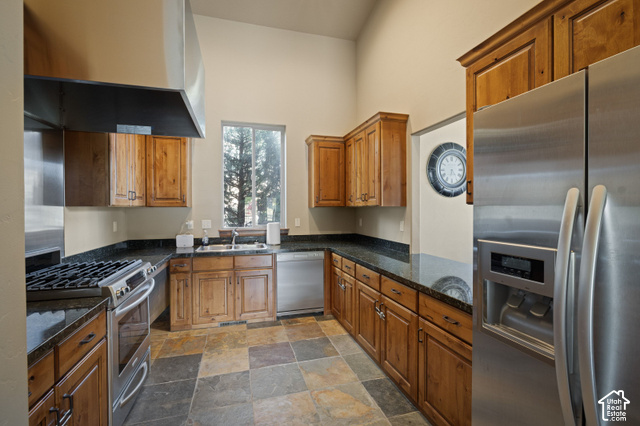 1141 520 West Midway, UT 84049 - Photo 29 of 40 Kitchen featuring stainless steel appliances, wood cabinetry, dark countertops, and varied-tone flooring