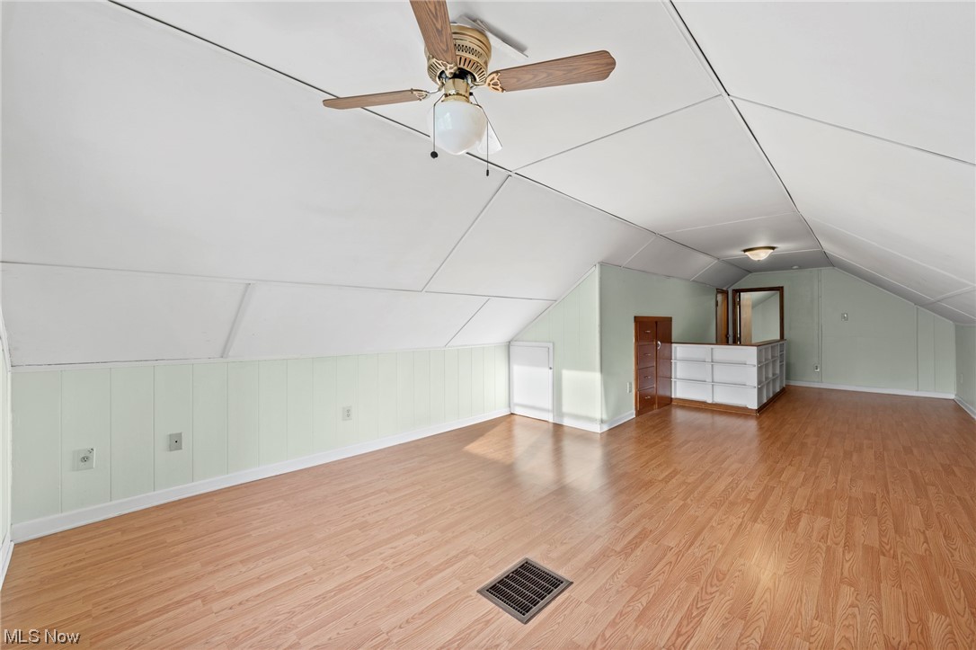 227 South Messner Road New Franklin, OH 44319 - Photo 37 of 44 Additional living space featuring ceiling fan, vaulted ceiling, and light wood-type flooring