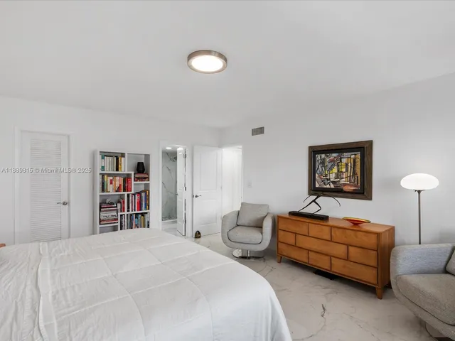 a bedroom with bed and a couch