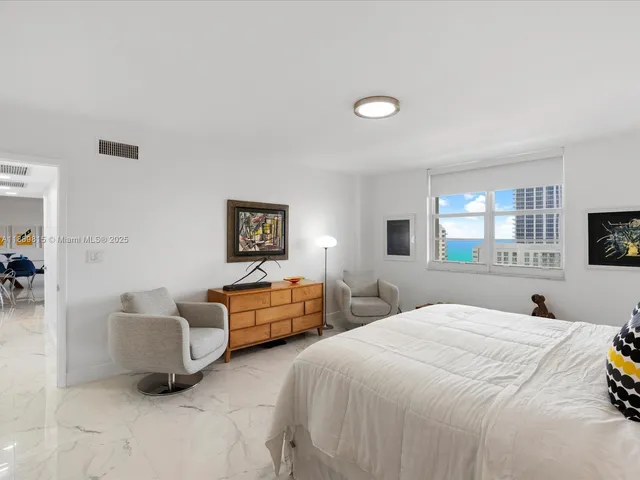 a bedroom with two beds and a flat screen tv