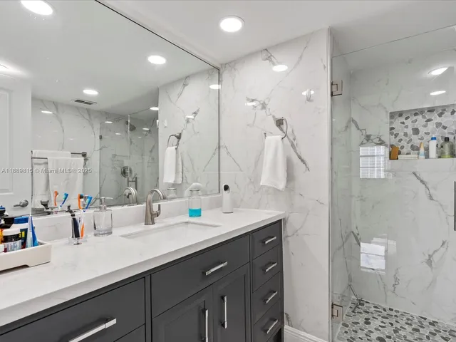 a bathroom with double vanity sink and a mirror