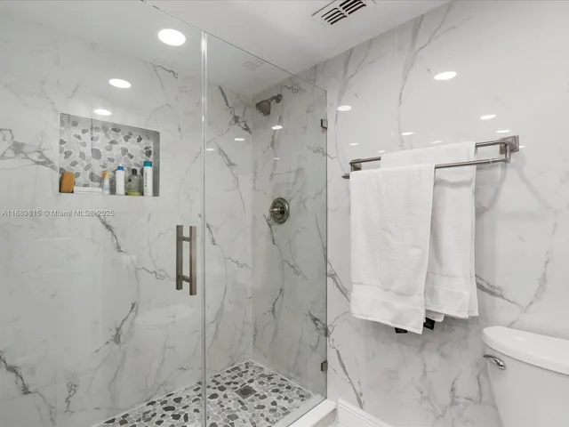 a bathroom with a shower and a toilet