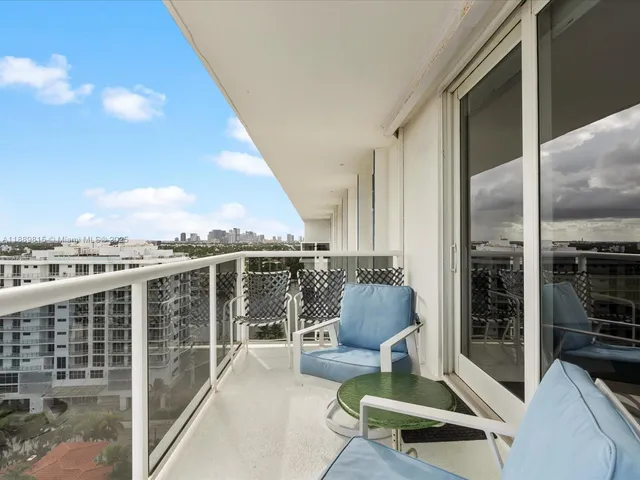 a balcony with furniture and a potted plant