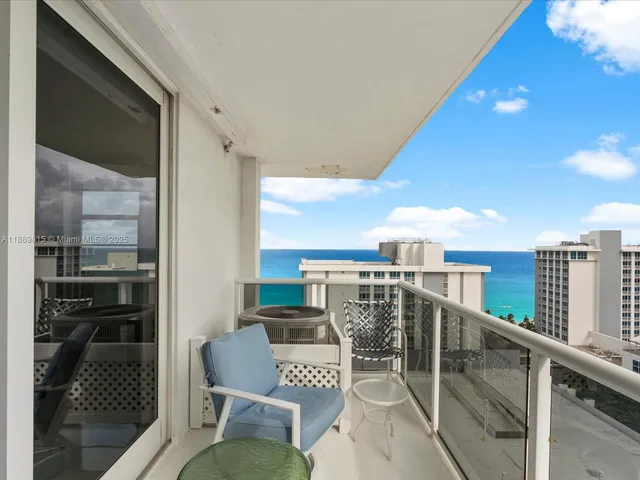 a balcony with table and chairs
