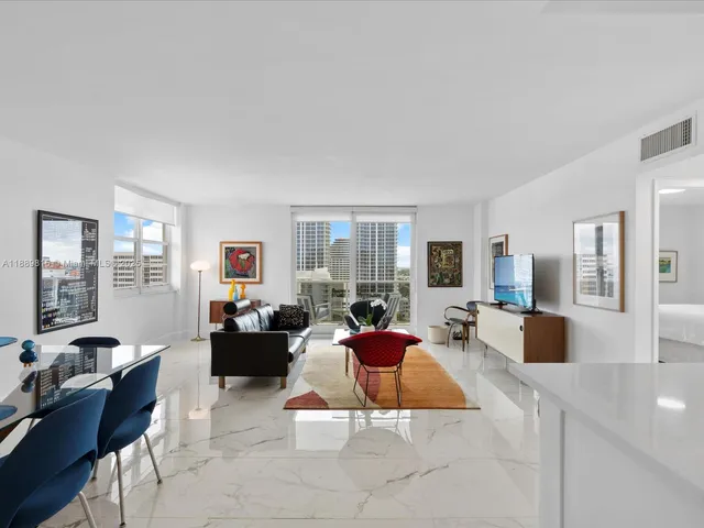 a living room with furniture large window and couch