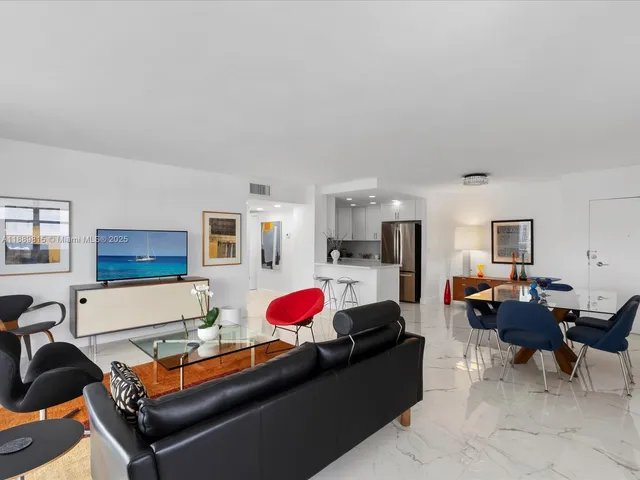 a living room with furniture a rug and a window