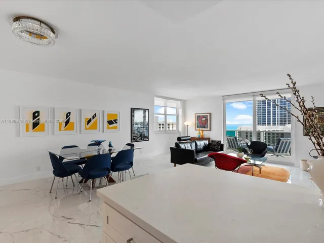 a living room with furniture chess board and a window