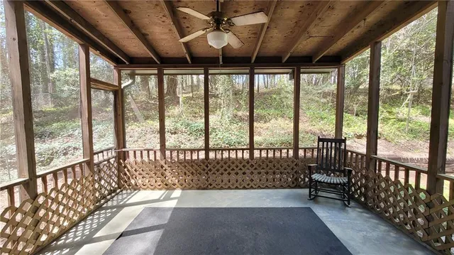 a view of a house with backyard and a tree