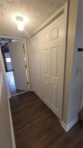 a view of a closet with wooden floor