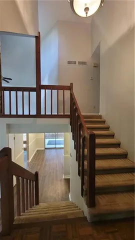 a view of a livingroom with wooden floor and stairs