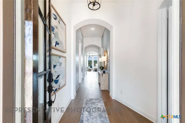 a view of a hallway view with wooden floor and living room