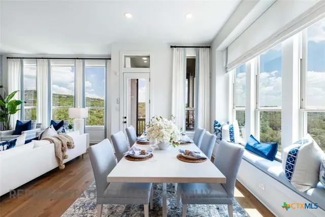 a view of a dining room with furniture window and wooden floor