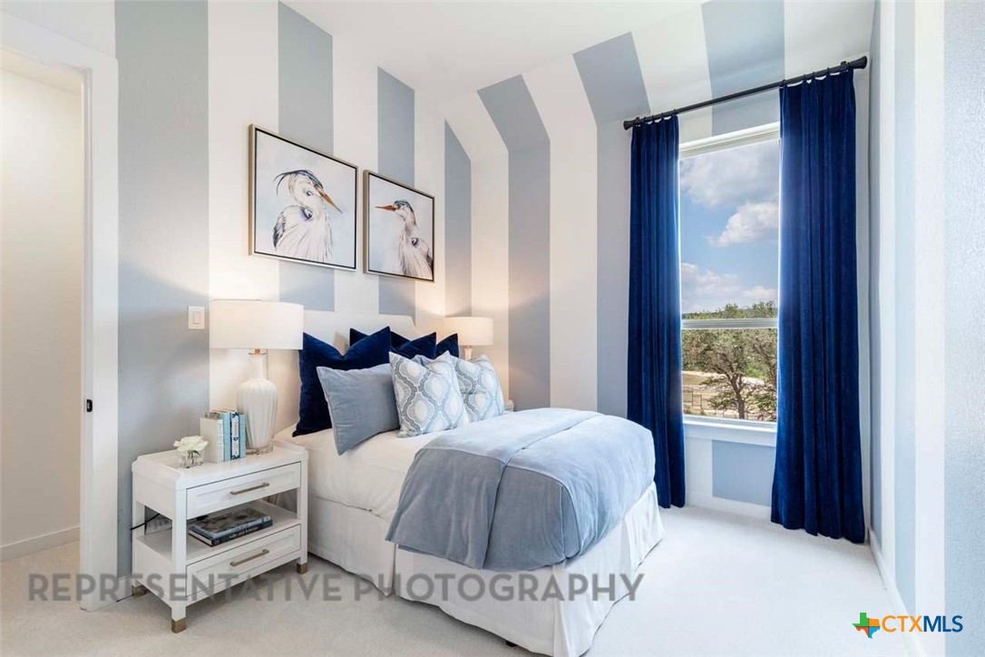 840 Jackson River Loop Kyle, TX 78640 - Photo 23 of 31 a bedroom with a bed and a window