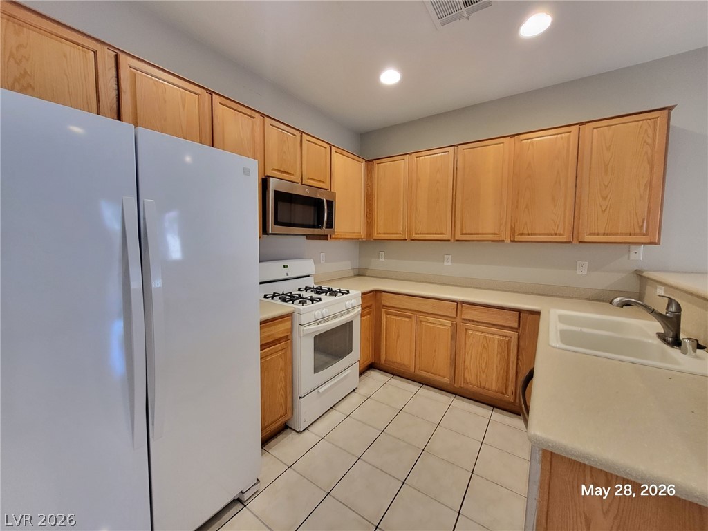 9843 West Overlook Ridge Avenue Las Vegas, NV 89148 - Photo 3 of 19 A well-appointed kitchen features ample cabinetry and essential appliances for everyday living.