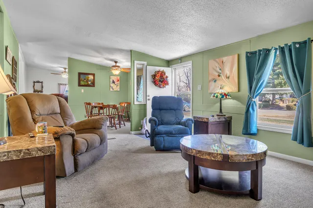 a living room with furniture and kitchen view