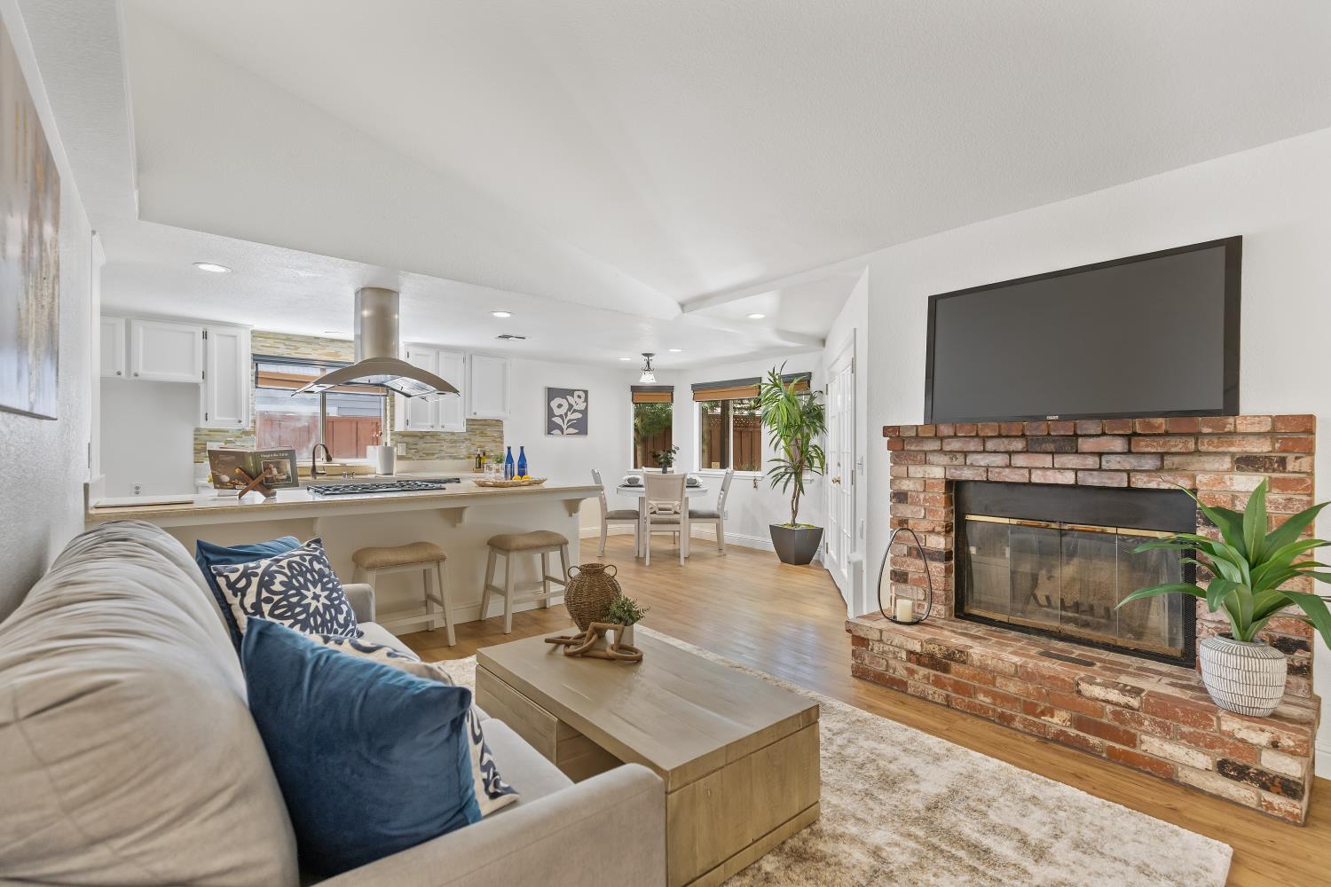 a living room with furniture a fireplace and a flat screen tv