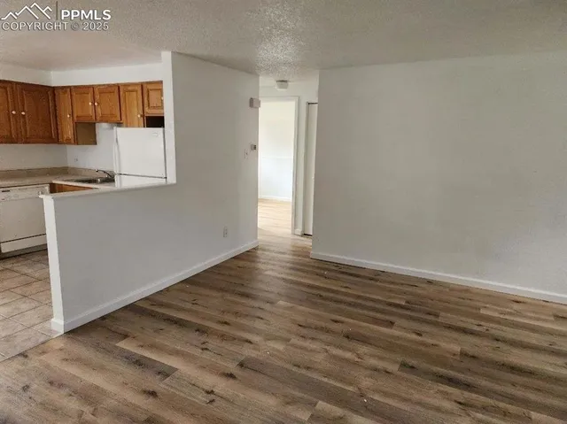 a view of kitchen with wooden floor and electronic appliances