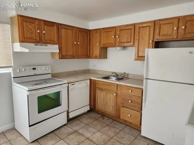 a kitchen with granite countertop cabinets and steel stainless steel appliances