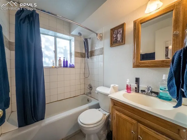 a bathroom with a sink toilet vanity and shower