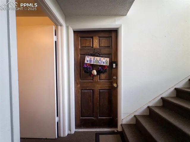 a view of a hallway with wooden floor and entryway