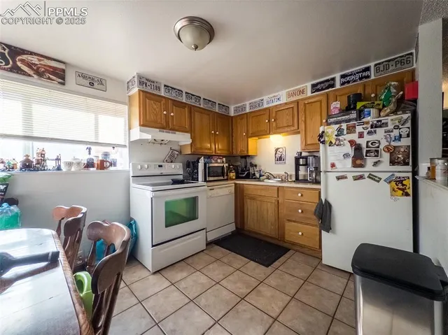 a kitchen with stainless steel appliances a stove a sink and a refrigerator