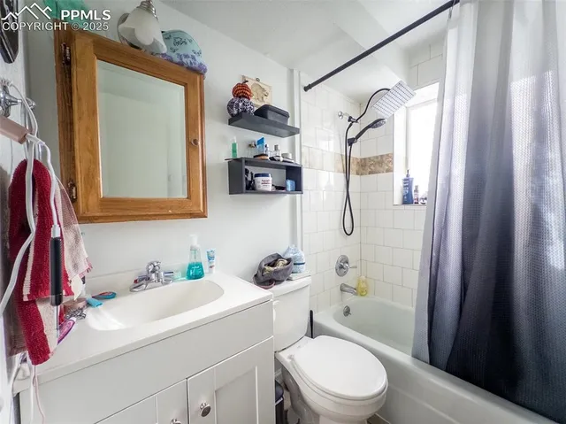 a bathroom with a sink vanity mirror and toilet
