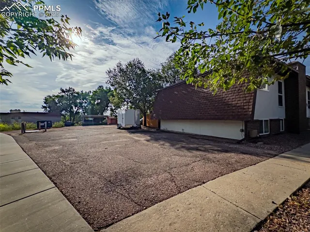 a view of a house with a yard and tree s