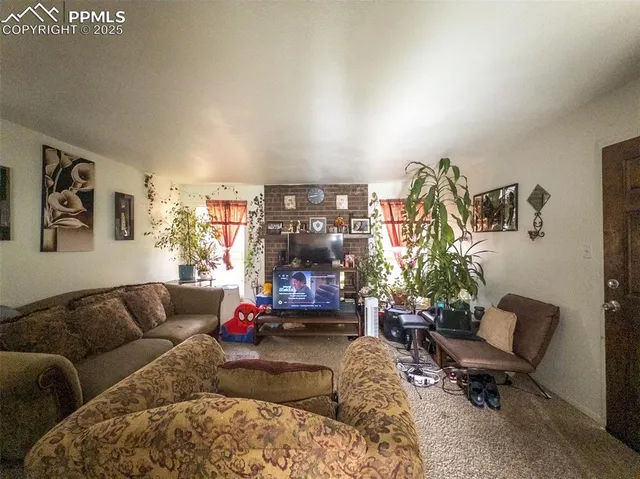 a living room with furniture kitchen and a window