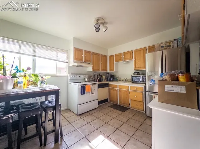 a kitchen with a sink appliances and cabinets