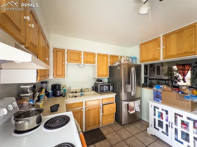 a kitchen with a sink stove and refrigerator