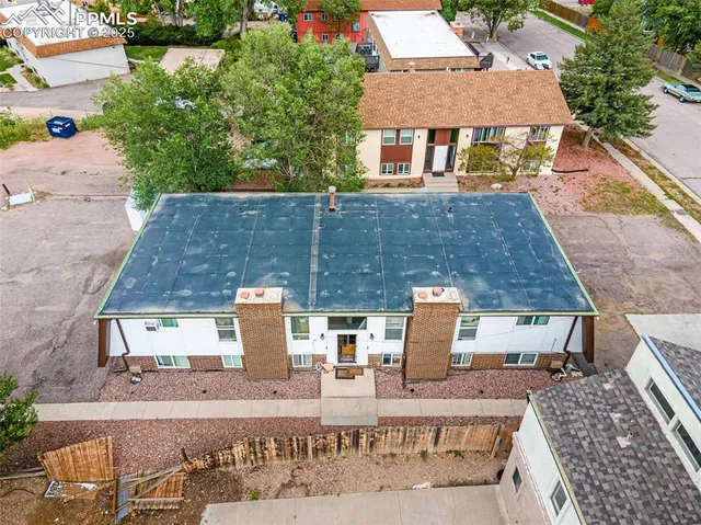 an aerial view of a house with outdoor space