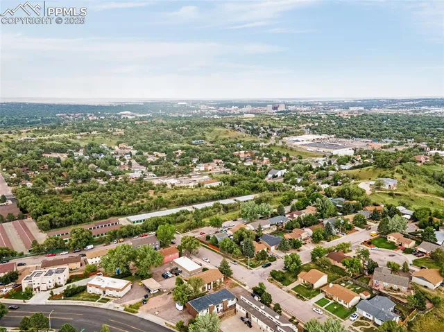 an aerial view of residential houses with city view