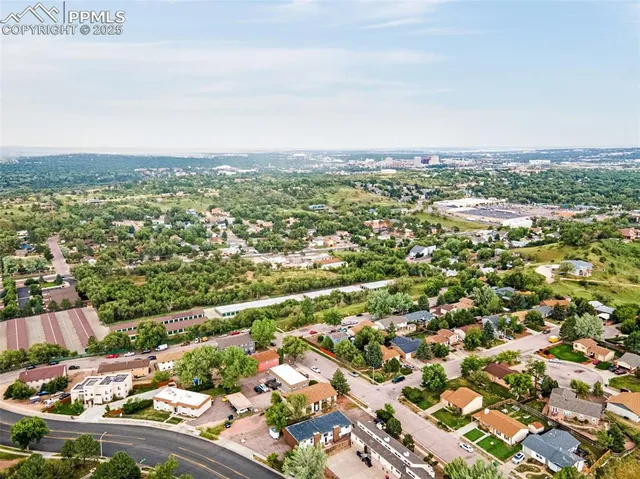 an aerial view of residential houses with city view