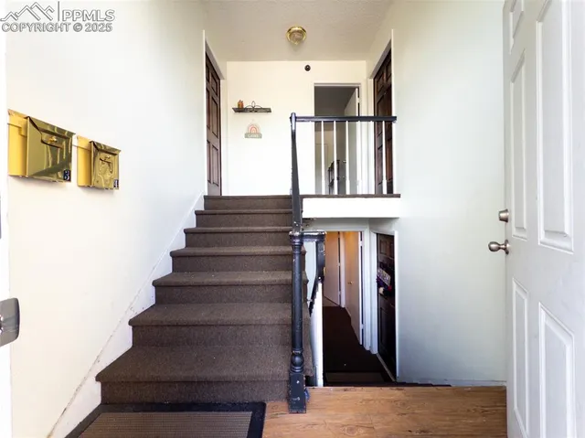 a view of entryway and hall with wooden floor